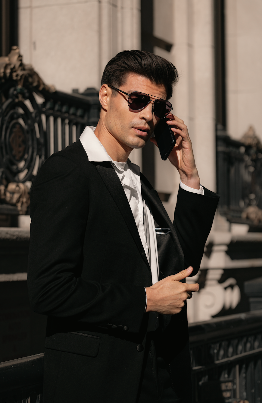 Man in a black suit and sunglasses