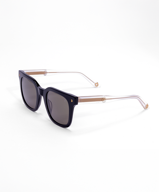A pair of sunglasses with black acetate frames and metal foil design on the arms, featuring anti-reflective coating.