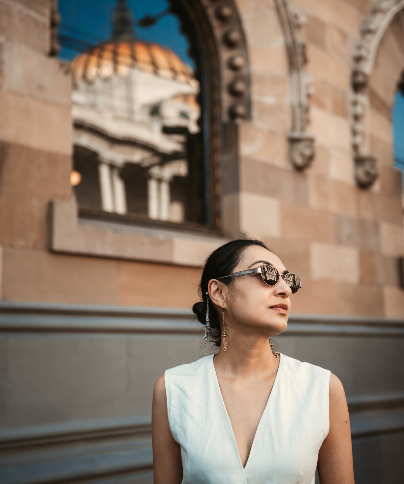 Woman wearing sunglasses and  jhumki